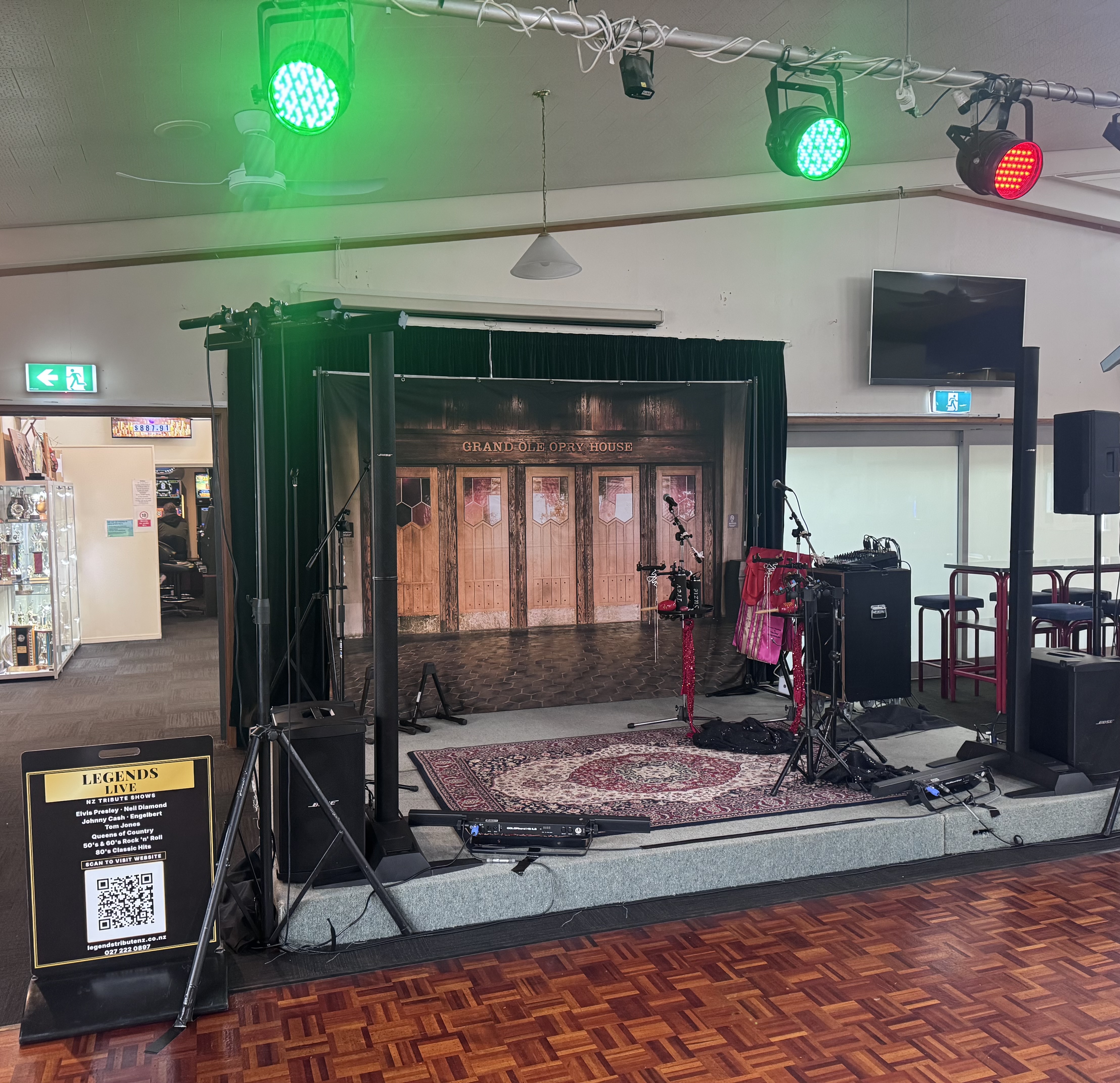 Grand Ole Opry House stage backdrop with lighting rig, Persian rug, and Legends Live NZ sign at Kamo 2026