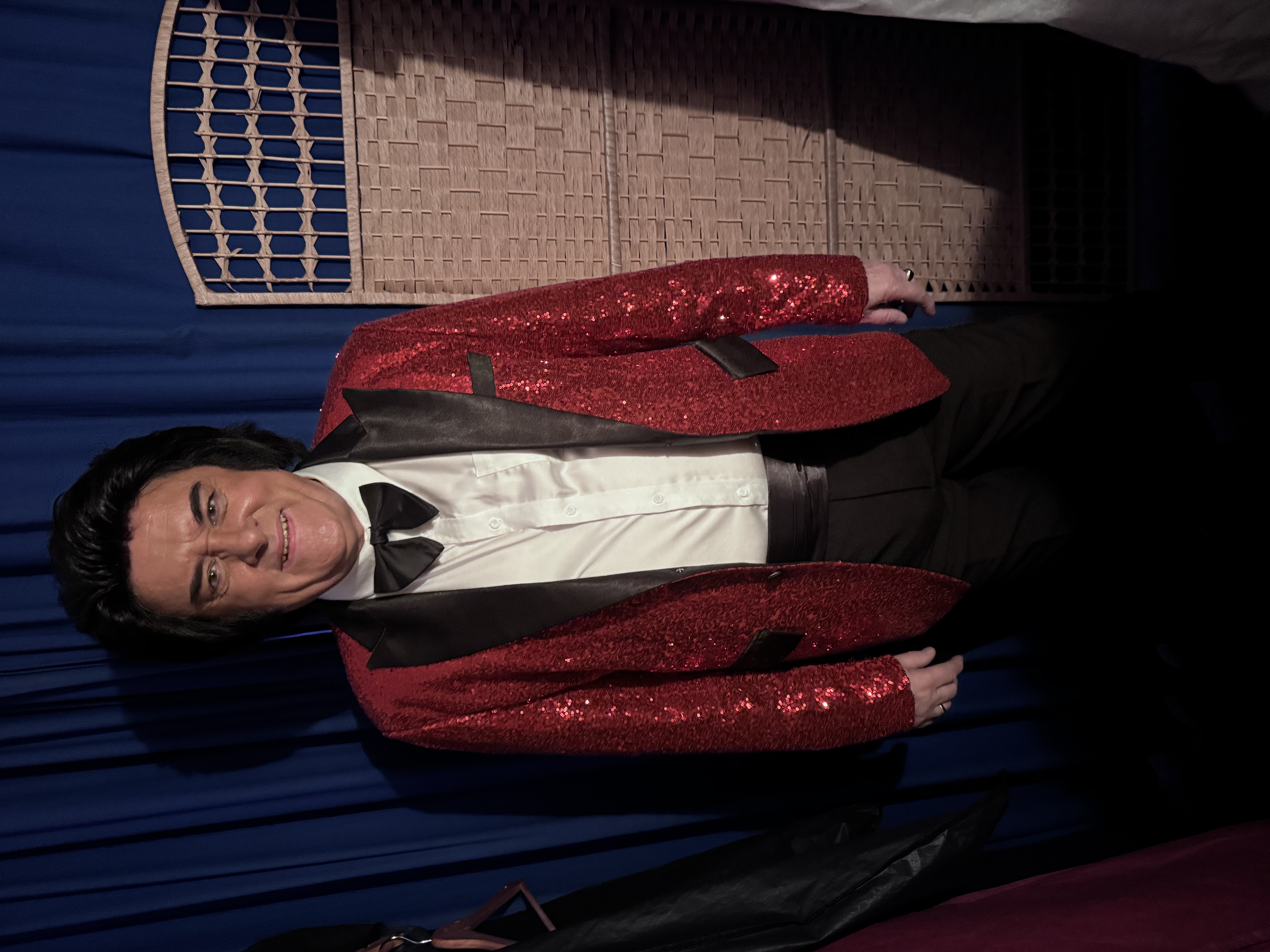 Trevor Needham as Engelbert Humperdinck in a red sequin jacket and bow tie, ready to perform at Kamo 2026